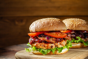 Close up of home made delicious burger on a wooden table.