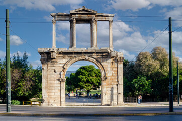 Fototapeta na wymiar Athens, Attica, Greece. The Arch of Hadrian, most commonly known in Greek as Hadrian's Gate, is a monumental gateway resembling, in some respects, a Roman triumphal arch. Sunny day