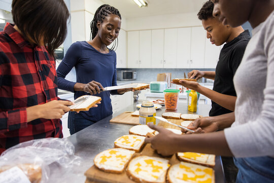 Volunteers making sandwiches in community center kitchen