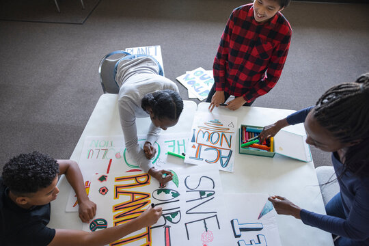 Teen activists making environmental posters in community center