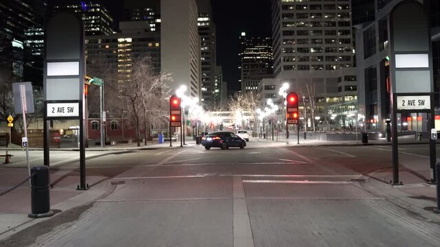 Calgary Alberta Canada, April 07 2021: Point of view tracking motion of a downtown intersection at night on the streets of a Canadian City