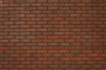 Fototapeta na wymiar The texture of a decorative brick is brown. Close-up 