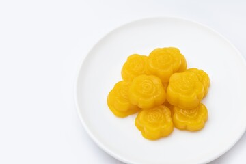 Kanom Thong-ake , traditional sweet dessert originating in Thailand, serving on white plate isolated on white