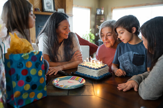 Family celebrating birthday of senior woman at home