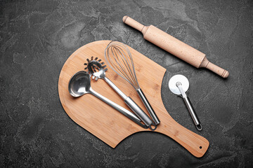 Set of kitchen utensils on dark background