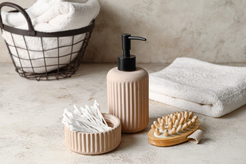 Bowl with cotton swabs and bath supplies on table in bathroom