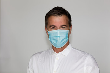 Man worker with mask looking at the camera. COVID-19 protection concept. Isolated on white	