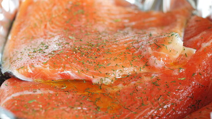 Close up of seasoned rainbow trout steak prepared to go into a cooker.