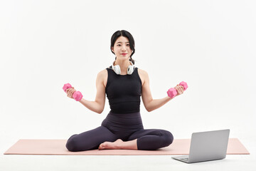 Fototapeta premium Asia Korean Girl training at white background , watching videos on laptop, and live streaming using gimbal in sns