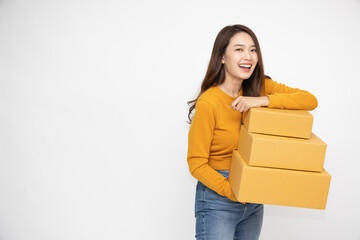 Happy Asian woman smiling and holding package parcel box isolated on white background, Delivery courier and shipping service concept