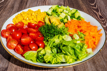 Salad ingredients Carrot, Avocado, Cucumber, Corn, Cherry Tomatoes. Healthy Vegetarian Food