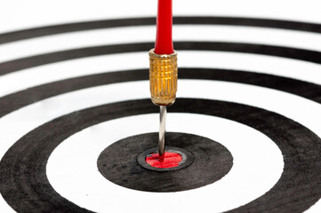 Red arrow hit on target dart board, business strategy planning to success goal.