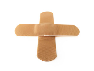 Aerial view of Cross bandaid isolated on white background. Protective tape strip, wound patch close up. First aid adhesive plaster First aid and sanitary equipment concept.