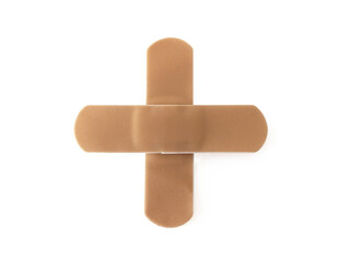 Aerial view of Cross bandaid isolated on white background. Protective tape strip, wound patch close up. First aid adhesive plaster First aid and sanitary equipment concept.