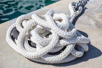Mooring rope white color on luxury yachts marina pier