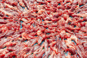 Sun-dried meat sliced in rattan basket, pattern and background.