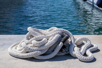 Mooring rope white color on luxury yachts marina pier