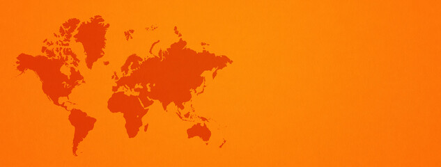 World map on orange wall background. Horizontal banner