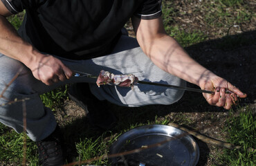 hand picking up meat