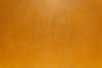 Abstract patten of golden grunge textured wallpaper background in gold color. Gold paper wallpaper on the wall.