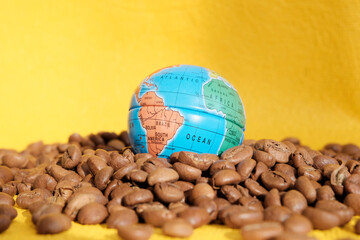 globe, coffee beans, yellow background