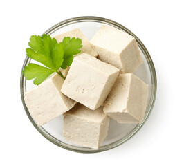 Diced tofu cheese with parsley in a plate on a white background, isolated. The view from top