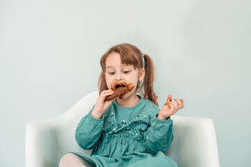 Adorable baby girl with face covered in chocolate