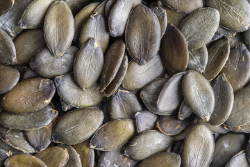 Macro background texture of green pumpkin seeds