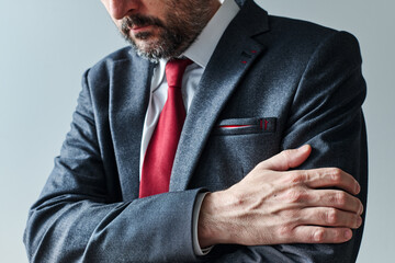 Arms gripping, restrained insecure businessman waiting for bad news
