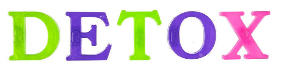 The word detox is lined with multi-colored plastic letters, white background, isolate.