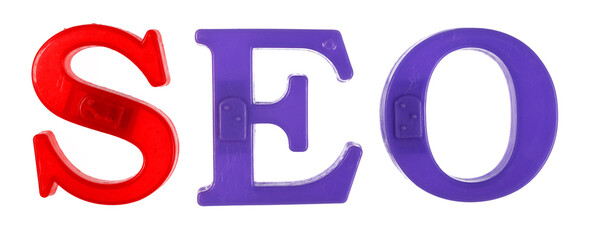 The word seo is lined with multi-colored plastic letters, white background, isolate.