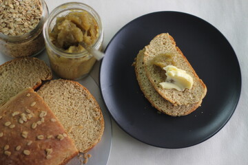 Home baked whole wheat bread with grape jam and butter.