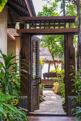 Wooden door to the exit from the tropical house to the sea, Thailand