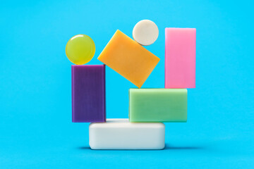 Multicolored soaps stack on a blue background. Variety of colorful soaps.