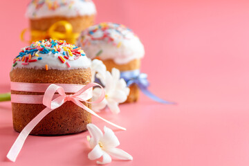 Traditional Easter cakes and Hyacinthus flowers on pink background with copy space for text. Traditional Kulich, Paska Easter Bread. Postcard