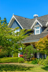A perfect neighborhood. Houses in suburb at Fall in the north America. Fragment of a luxury house with nice window.