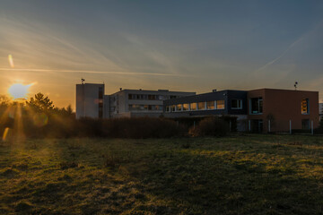 Fototapeta na wymiar Sunset in housing estate in Usti nad Labem city with big house Hotelak