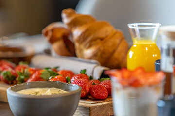 Breakfast served with coffee, orange juice, croissants, cereals and fruits