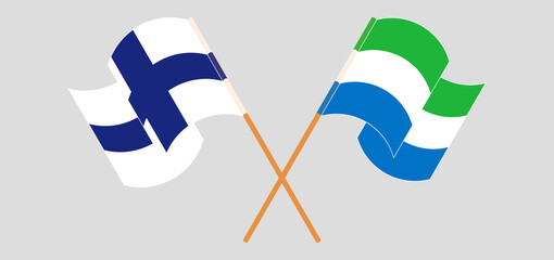 Crossed and waving flags of Finland and Sierra Leone