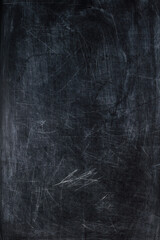 artistic creative dark black and gray old scratched shabby background with chalk stains. blackboard