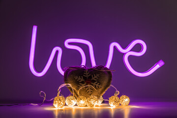 Heart-shaped fabric with a wooden snowflake decoration and lights in front of a 