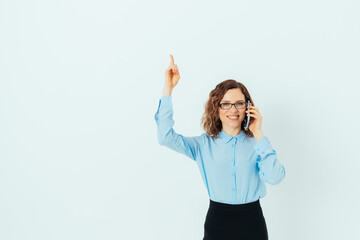 Smiling confident young business woman in glasses wearing blue shirt