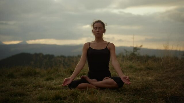 Yoga woman with closed eyes meditating. Fit woman doing namaste yoga pose