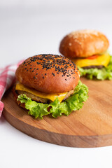 Two big tasty hamburger on white background wooden stand