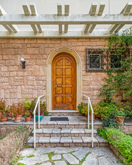 elegant house front stone covered steps and wooden door, Athens Greece.