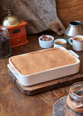 Tiramisu and coffee on a wooden background.
