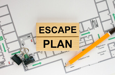 Construction drawings and wooden bars with text Escape Plan and paper clips