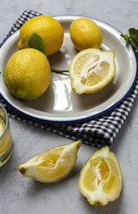 Fresh lemons with green mint leaves