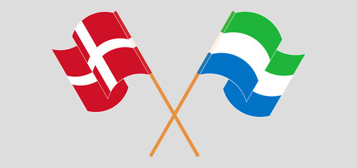 Crossed and waving flags of Denmark and Sierra Leone