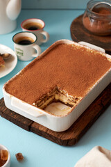 Tiramisu and coffee on a blue background.